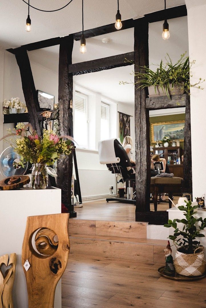 a mirror with a wooden frame and some plants