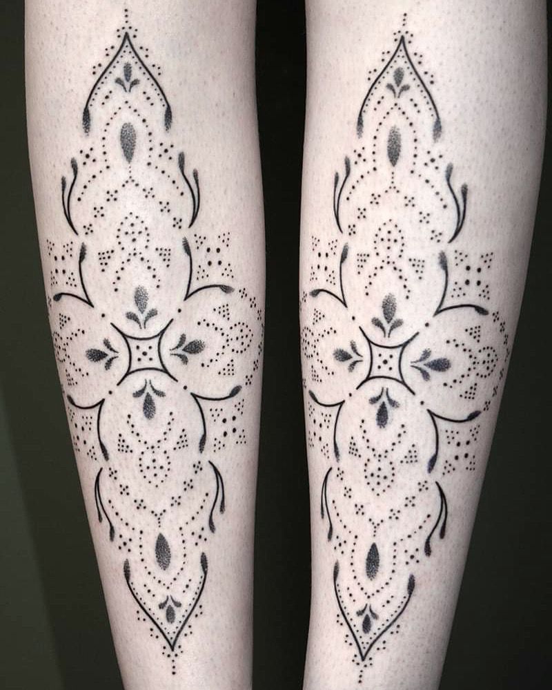 a woman's legs with a black and white narben tattoo design, passau, germany