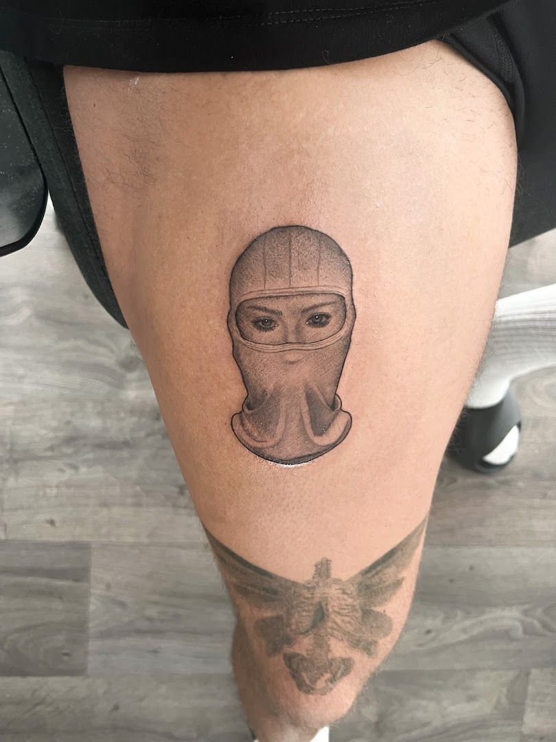 a cover-up tattoo of a man's face with a helmet on his leg, wartburgkreis, germany