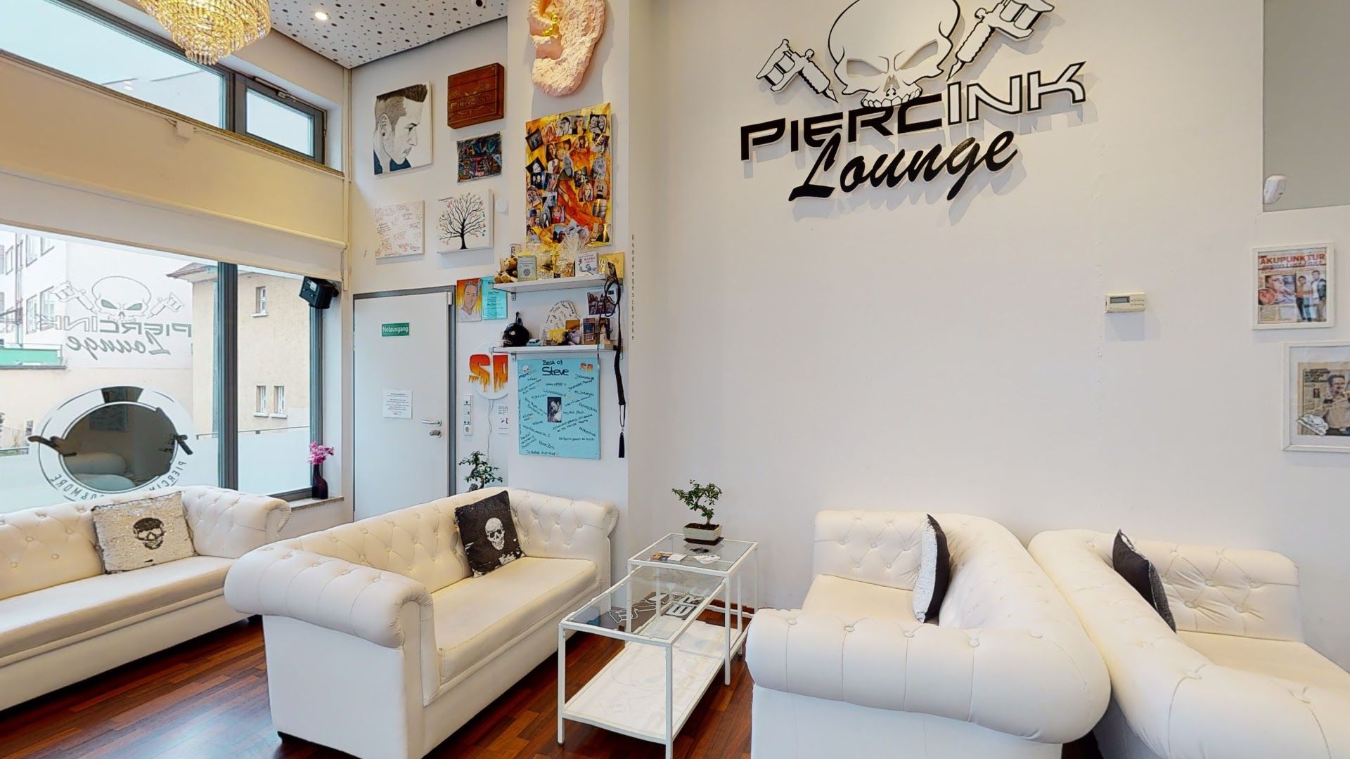 a living room with white couches and a large window