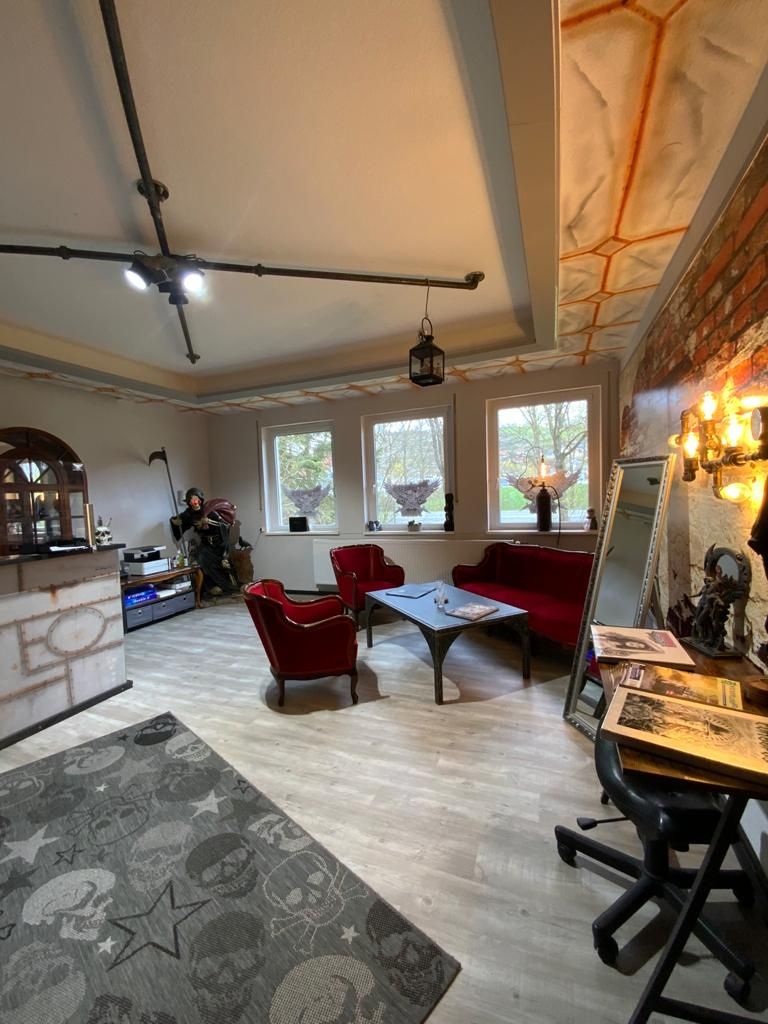 a living room with a couch, chair and fireplace
