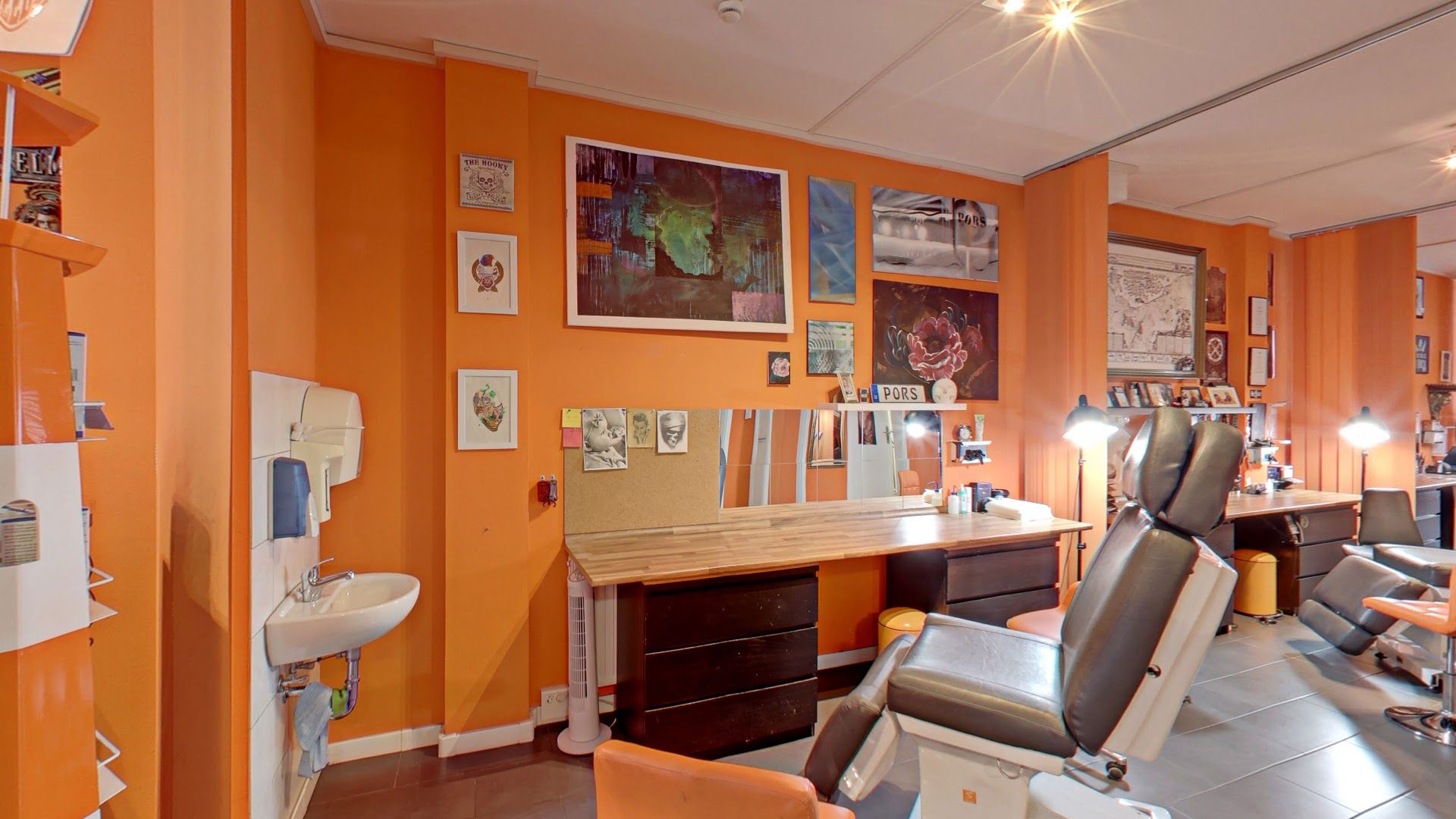a room with a chair, desk and a computer