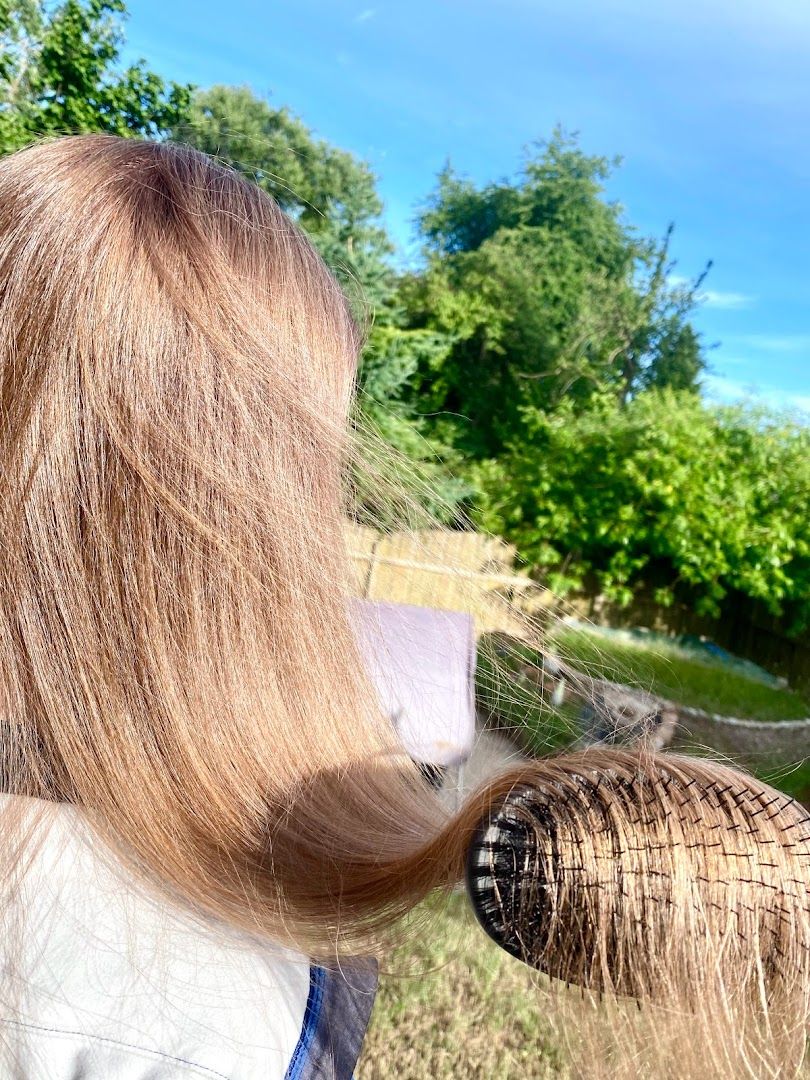 a woman with long hair and a white shirt