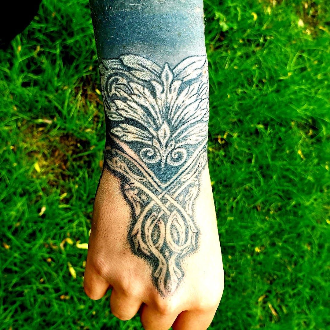 a cover-up tattoo on the wrist of a person, essen, germany