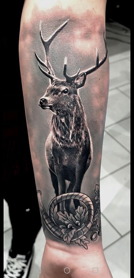 a blackwork tattoo of a deer with a compass on it, neumarkt, germany