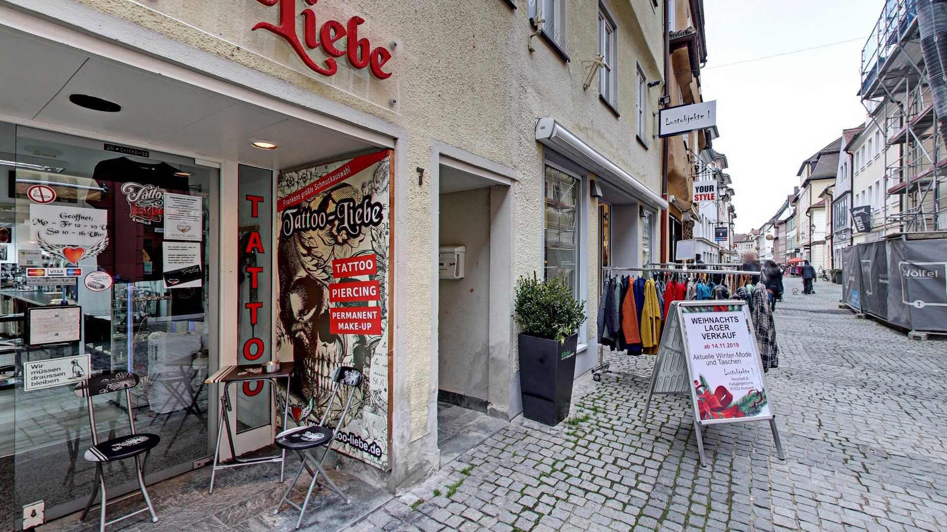 a street with a store front and a sign on the front