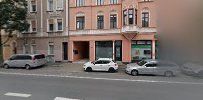 a street with cars parked on it and buildings in the background