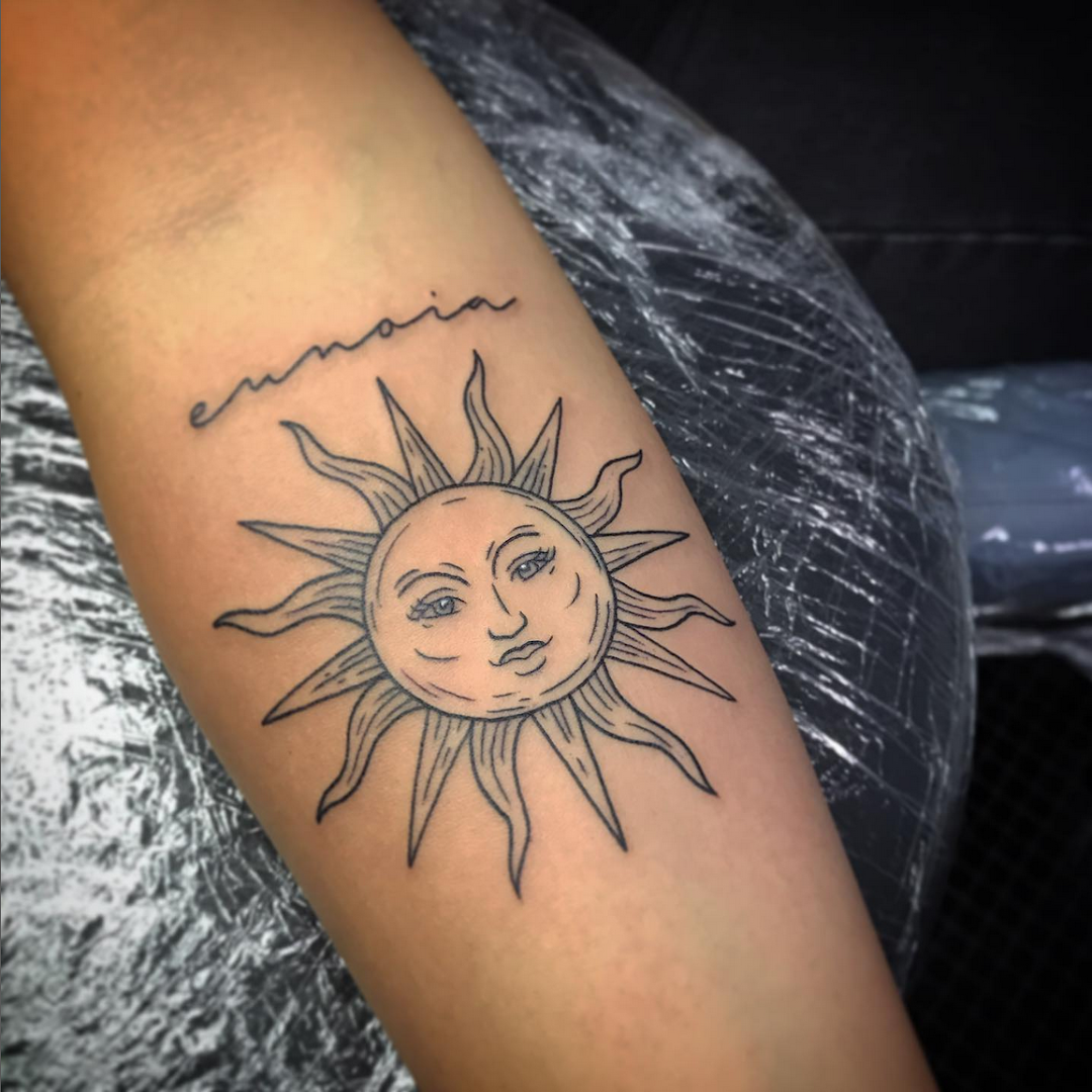 a cover-up tattoo of a sun with a face, kassel, germany