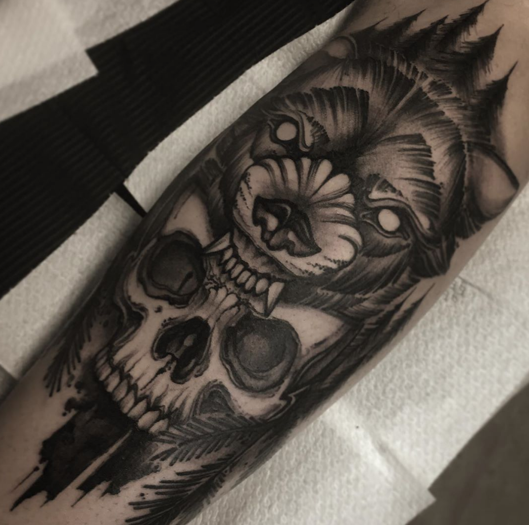 a black and white blackwork tattoo of a lion and skull, günzburg, germany