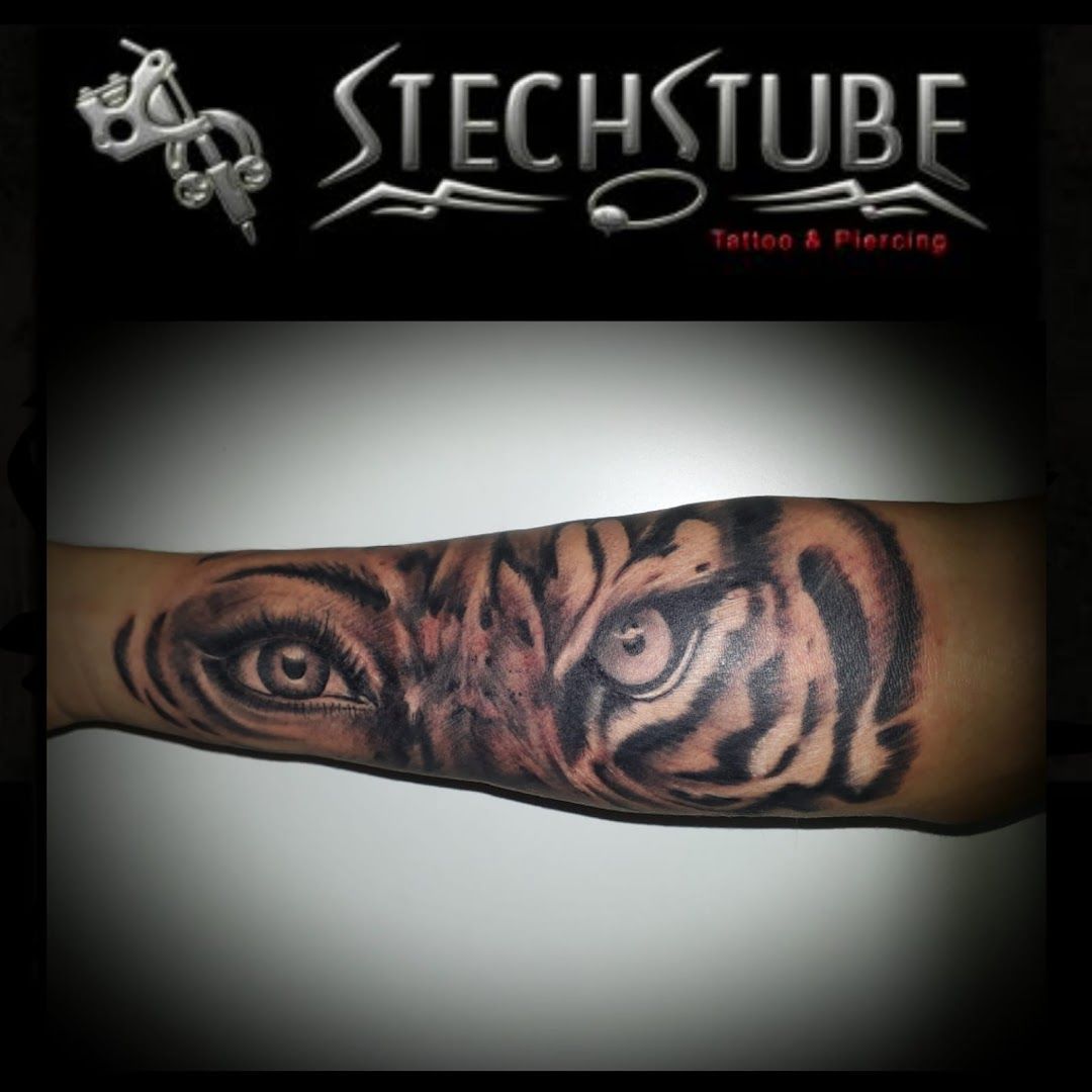 a tiger cover-up tattoo on the arm, reutlingen, germany