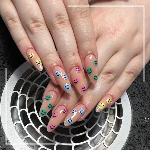 a woman with a colorful nail design on her nails