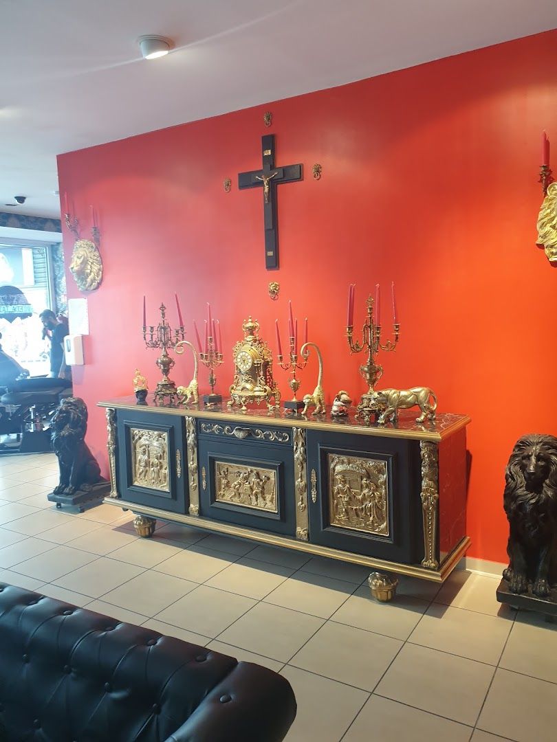 a black and gold buffet with a red wall