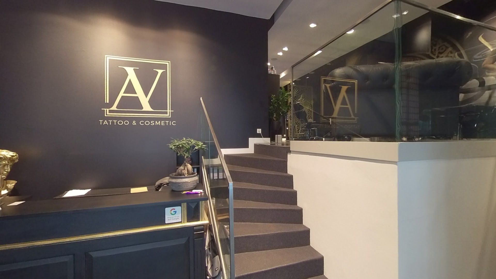 a reception area with a staircase and a glass wall