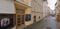 a narrow street with a television set on the wall