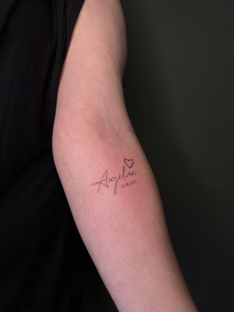 a woman's arm with a narben tattoo saying love, herford, germany