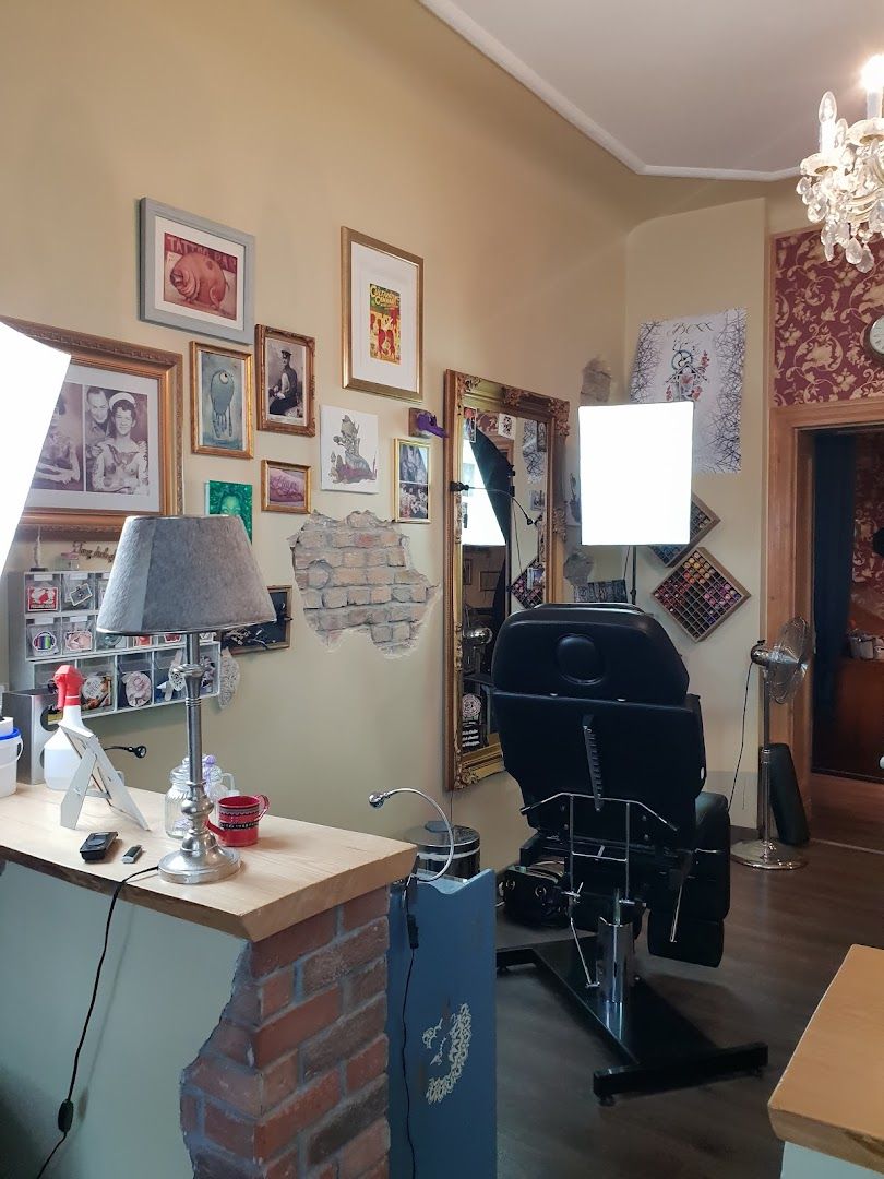 a room with a desk, chair, and a lamp