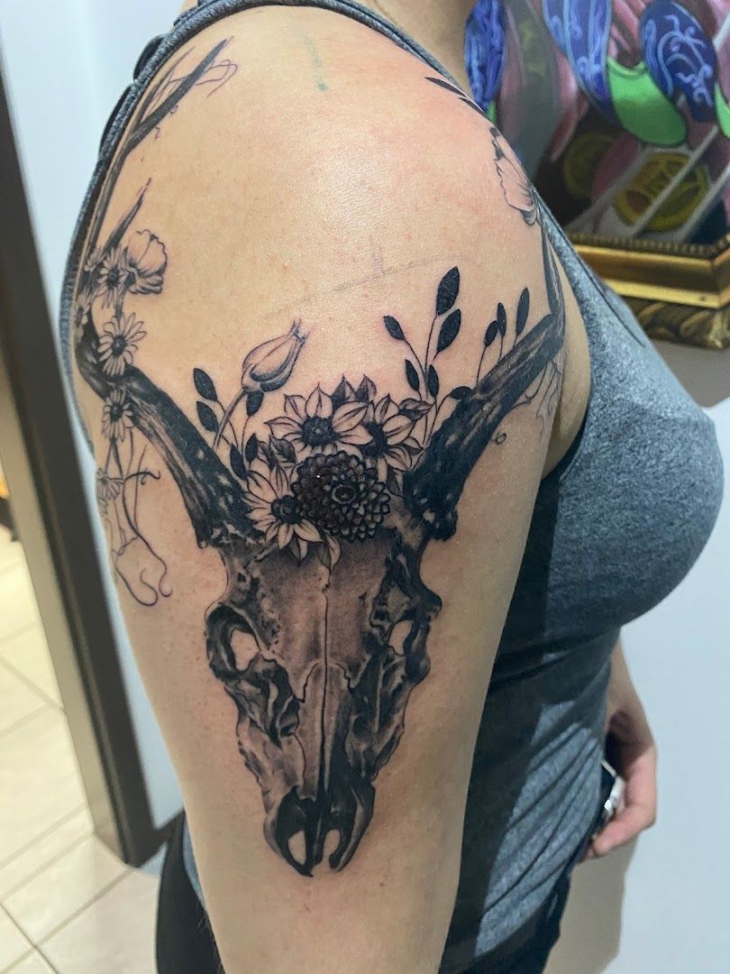 a black and white cover-up tattoo of a deer skull with flowers, amberg-sulzbach, germany