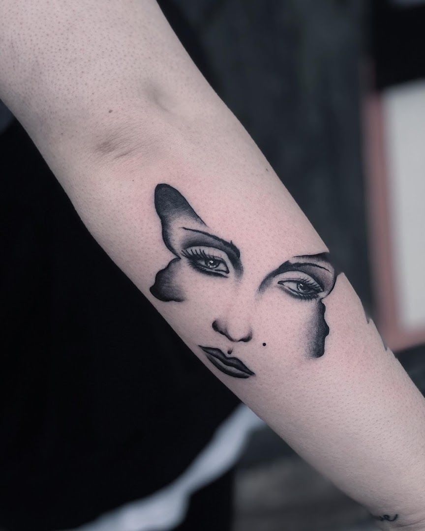 a woman's face with a black and white ink realistic tattoos, marburg-biedenkopf, germany