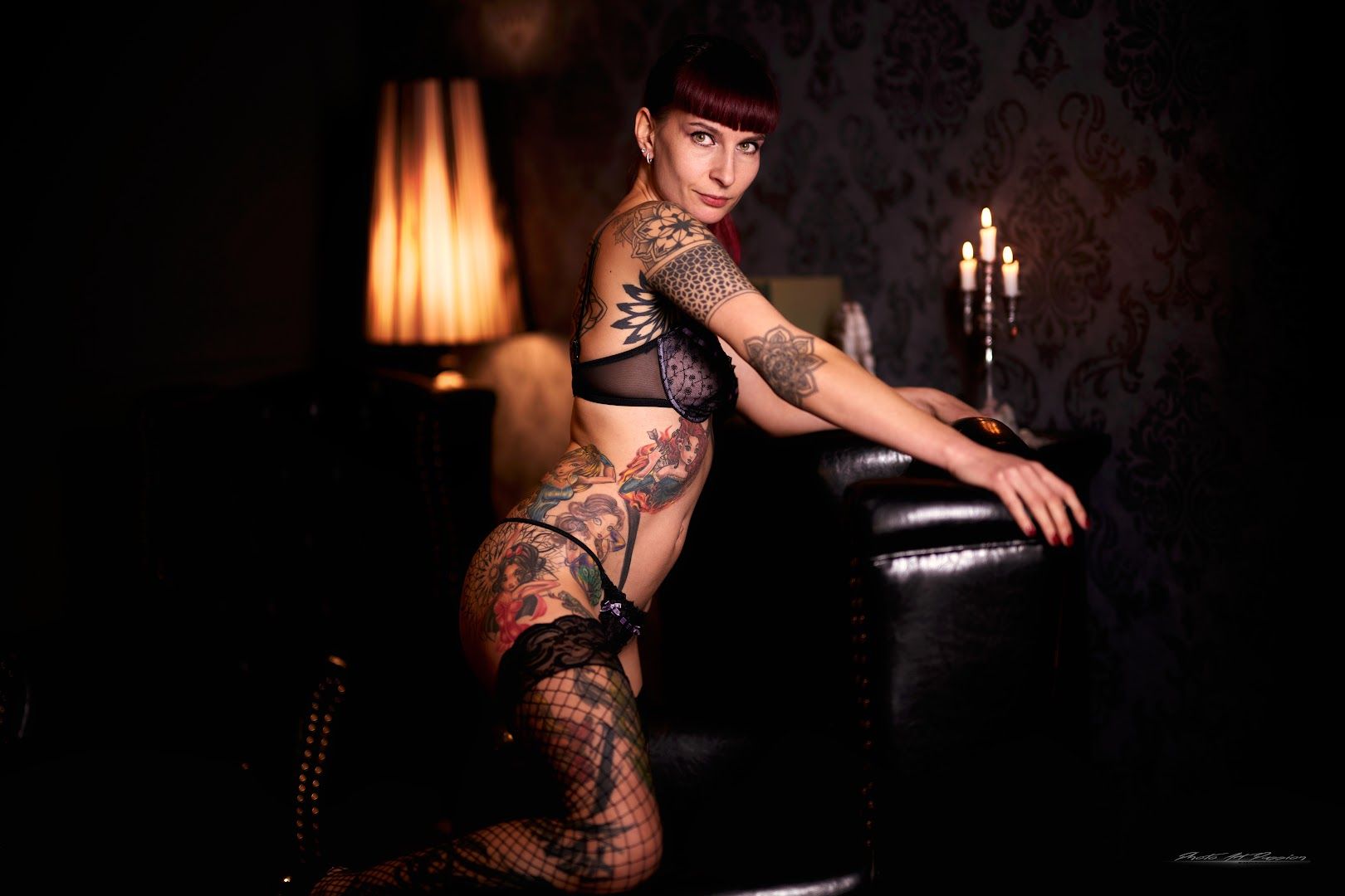 a woman with japanische tattoos in leipzigs sitting on a couch, karlsruhe, germany