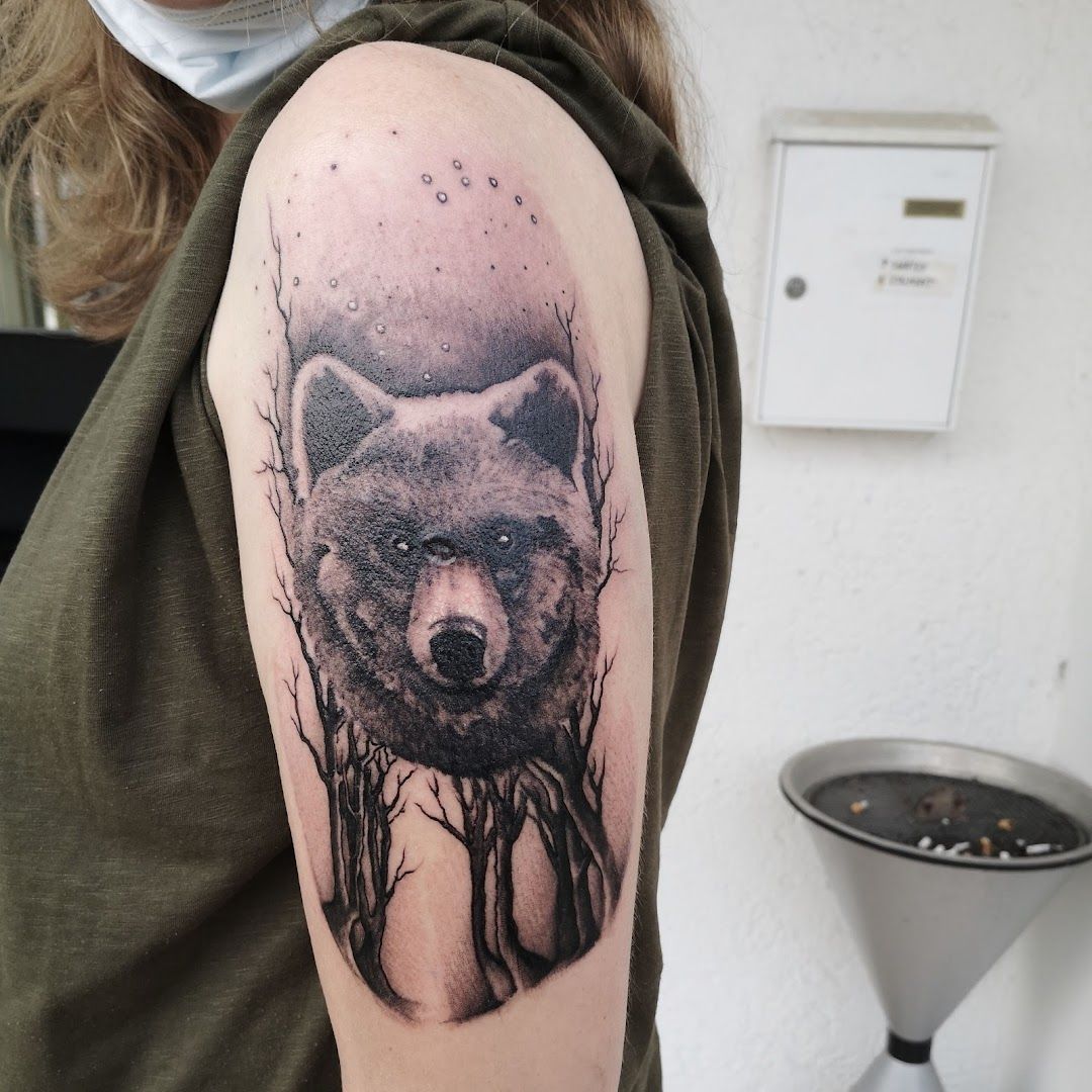 a black and white cover-up tattoo of a wolf with trees, bodenseekreis, germany