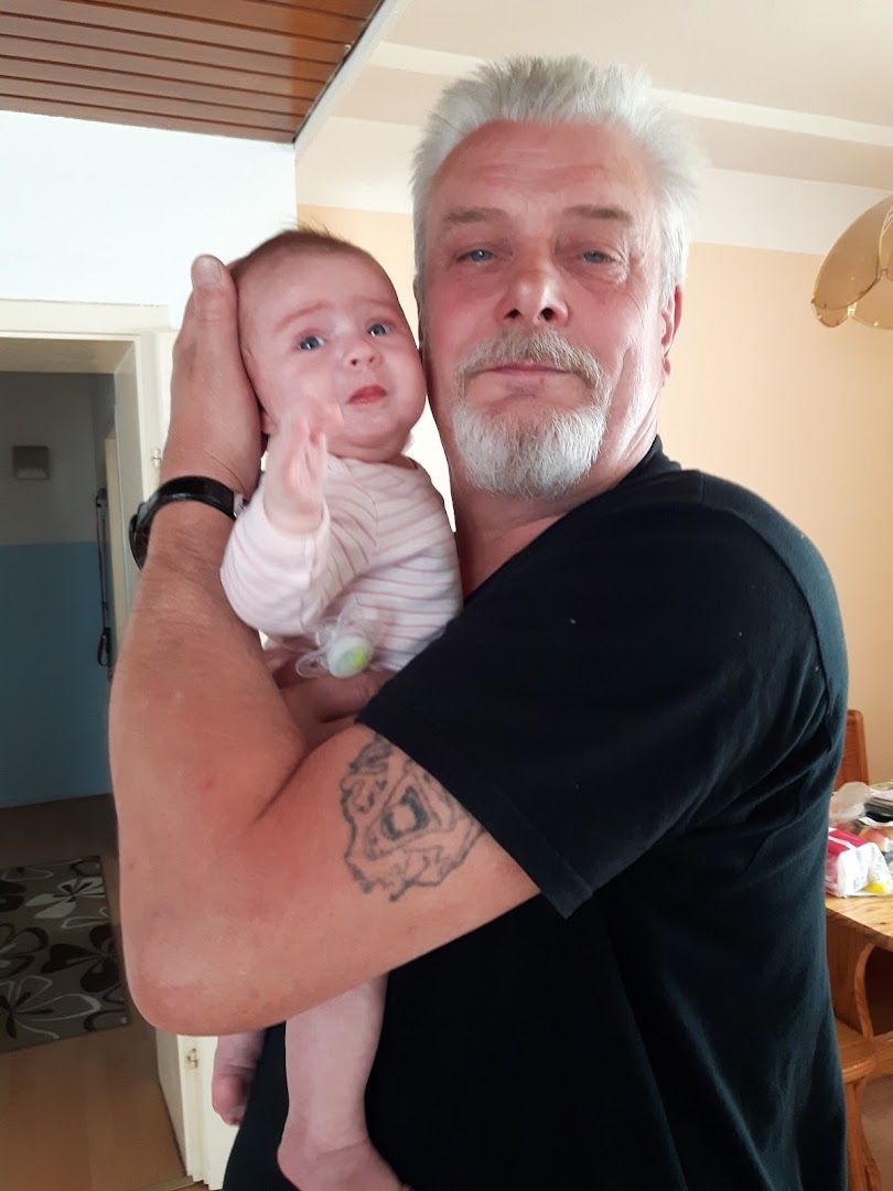 a man holding a baby in his arms