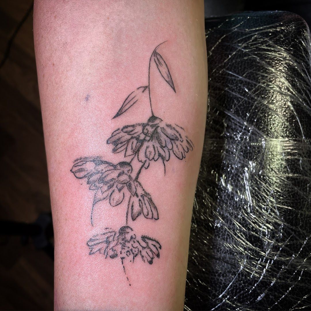 a cover-up tattoo of a humming on the arm, bonn, germany