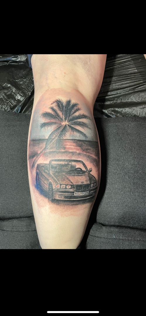 a man with a car and palm trees on his leg