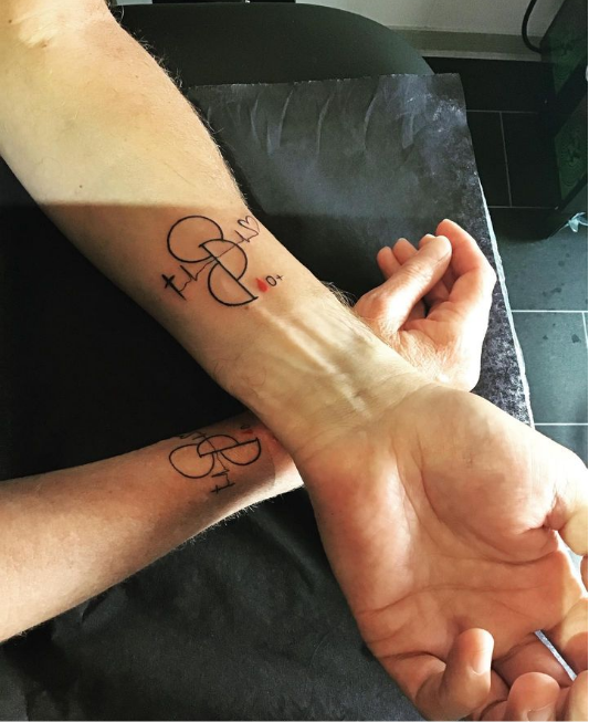 a couple holding hands with a narben tattoo on their wrist, neunkirchen, germany