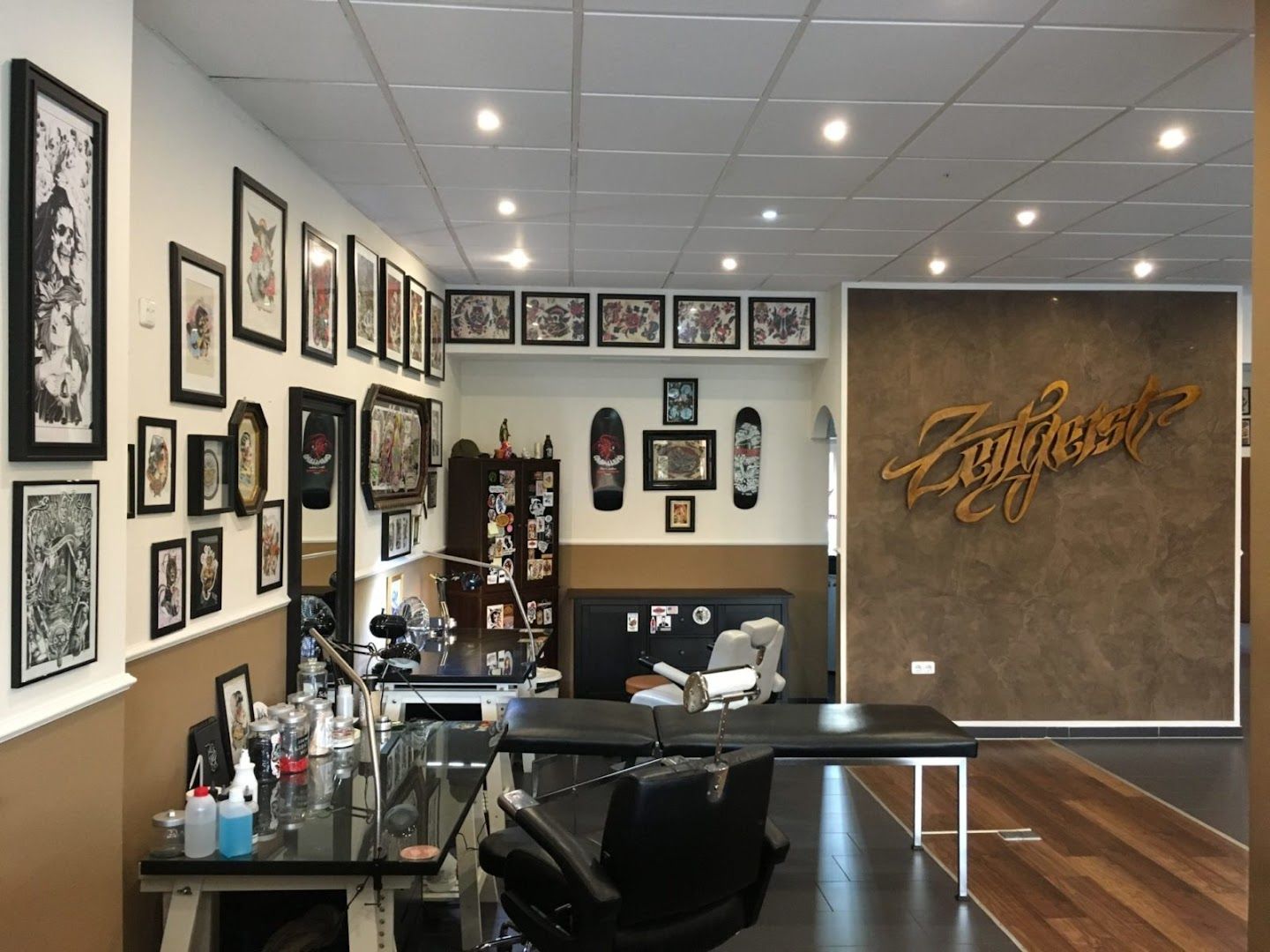 a room with a desk and pictures on the wall