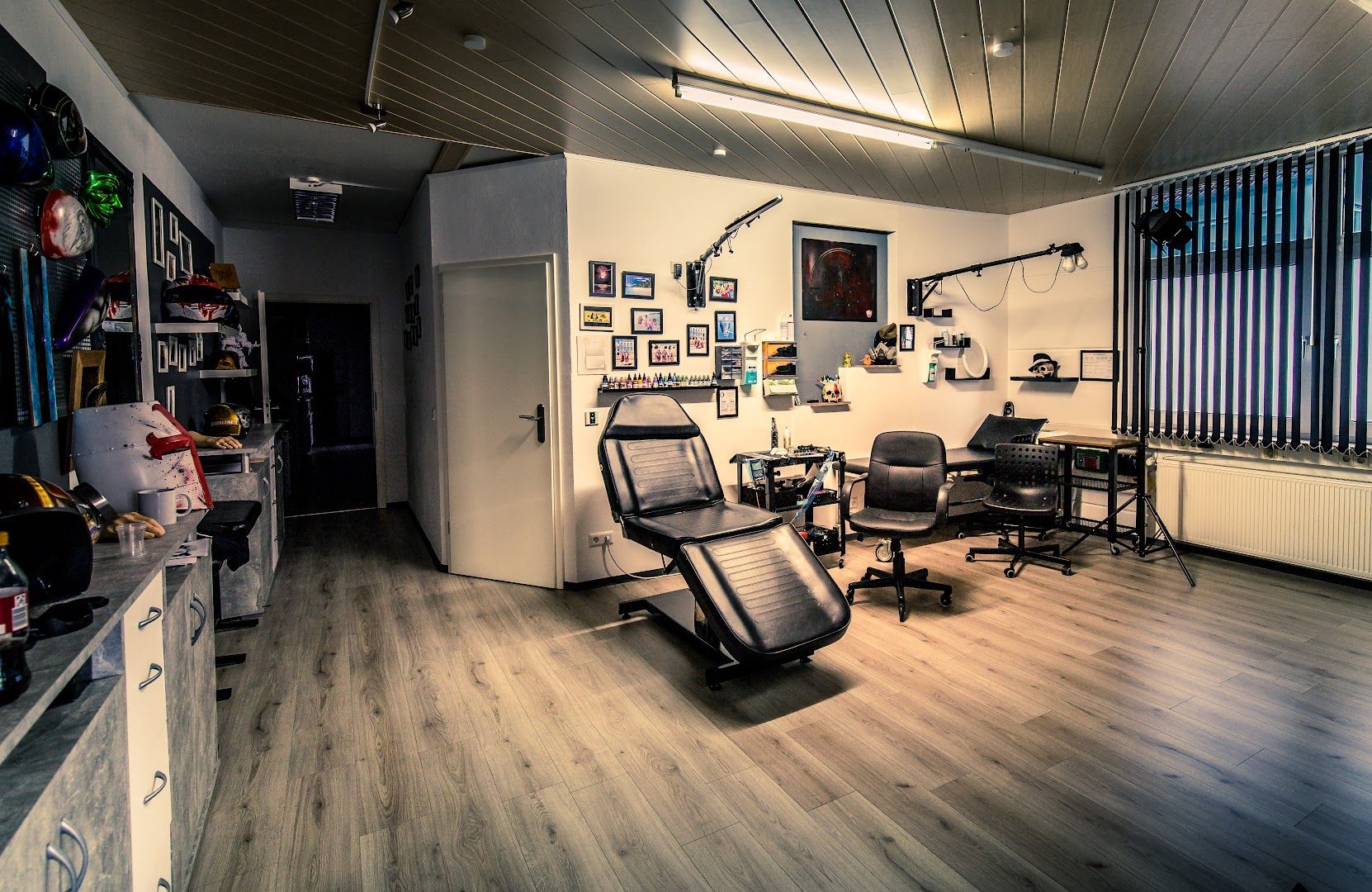 a room with a chair, a desk, and a television