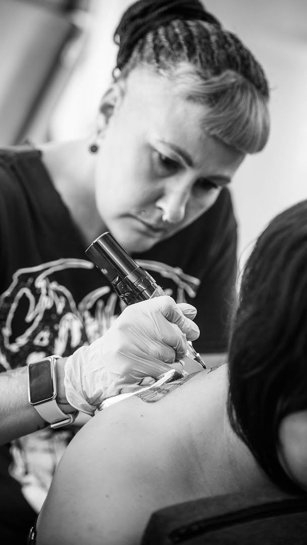 a woman getting her cover-up tattoo done by a tattooist, bad kreuznach, germany