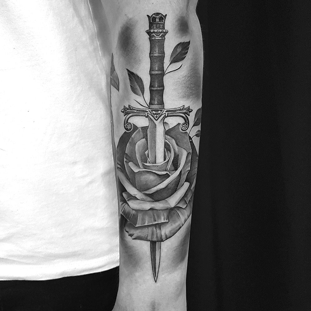 a man with a sword and rose cover-up tattoo on his arm, paderborn, germany