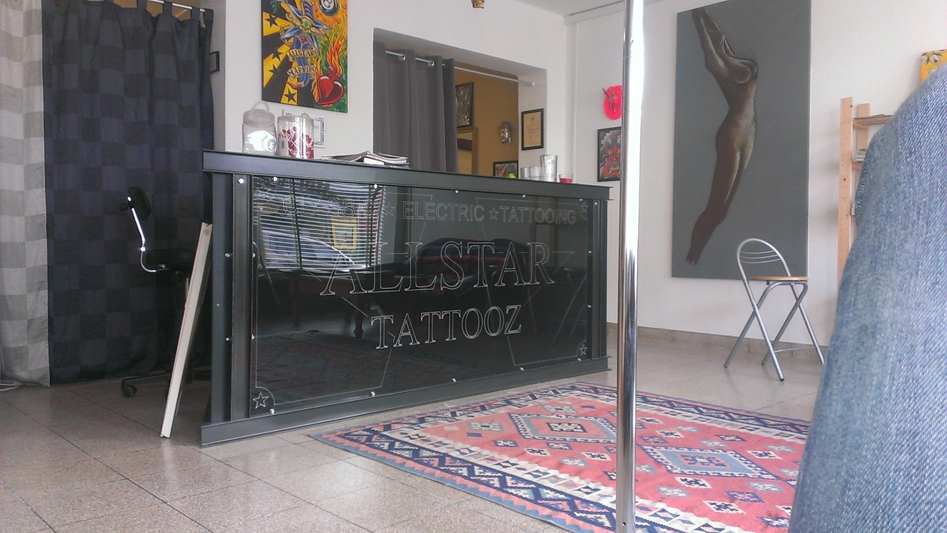 a room with a large rug and a black cabinet