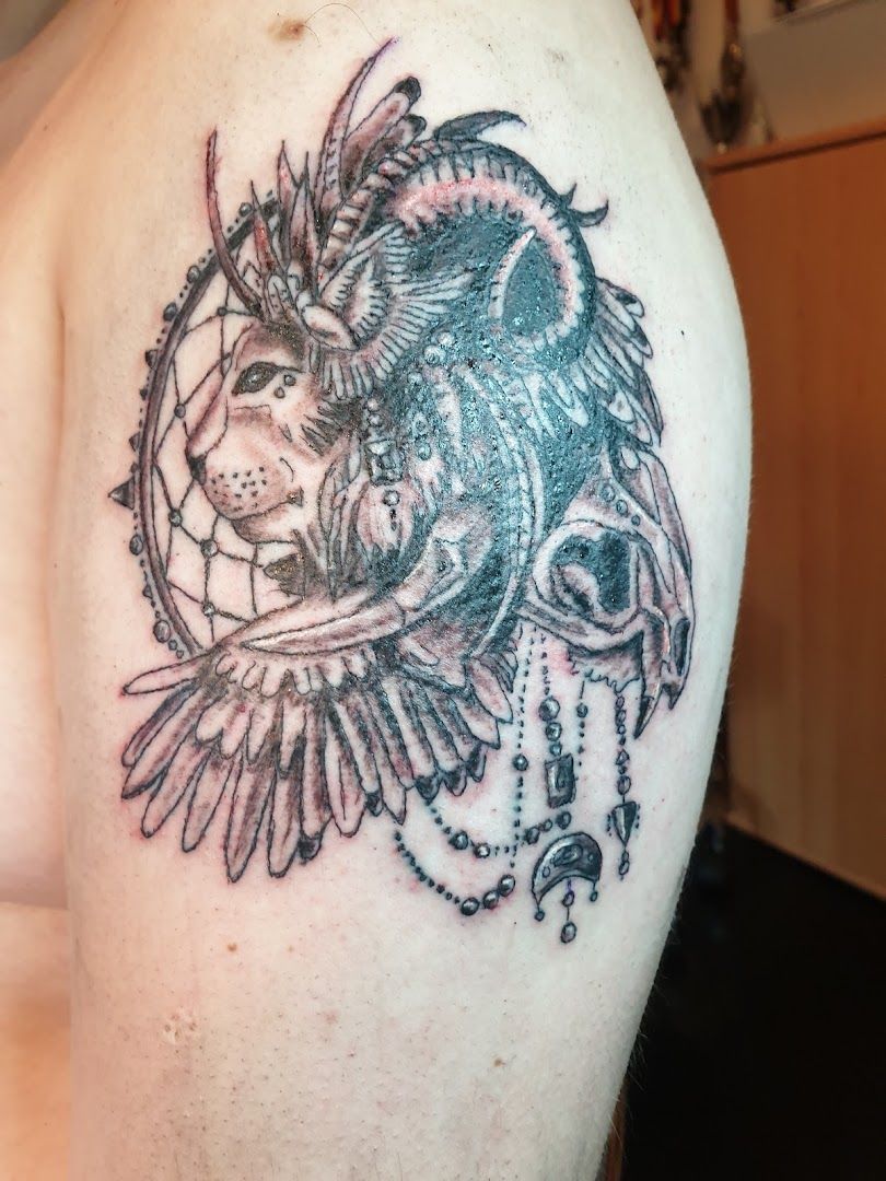 a narben tattoo of a lion and a bird, ammerland, germany