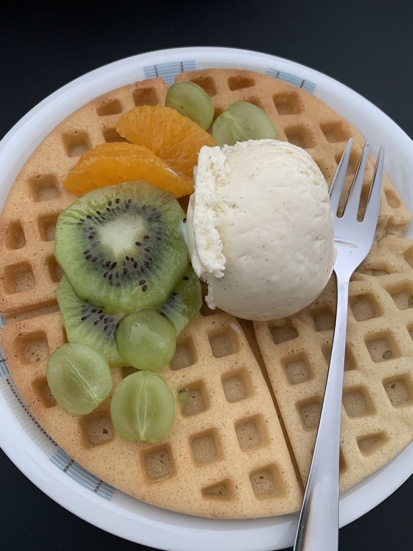 a plate of was with fruit and ice cream