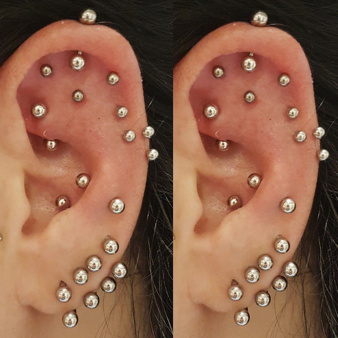 a pair of piercings with silver balls