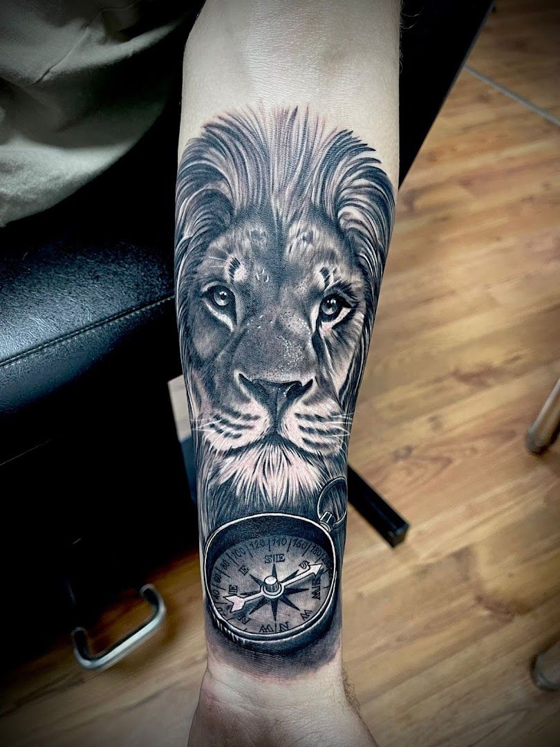 a black and white cover-up tattoo of a lion with a compass, heilbronn, germany