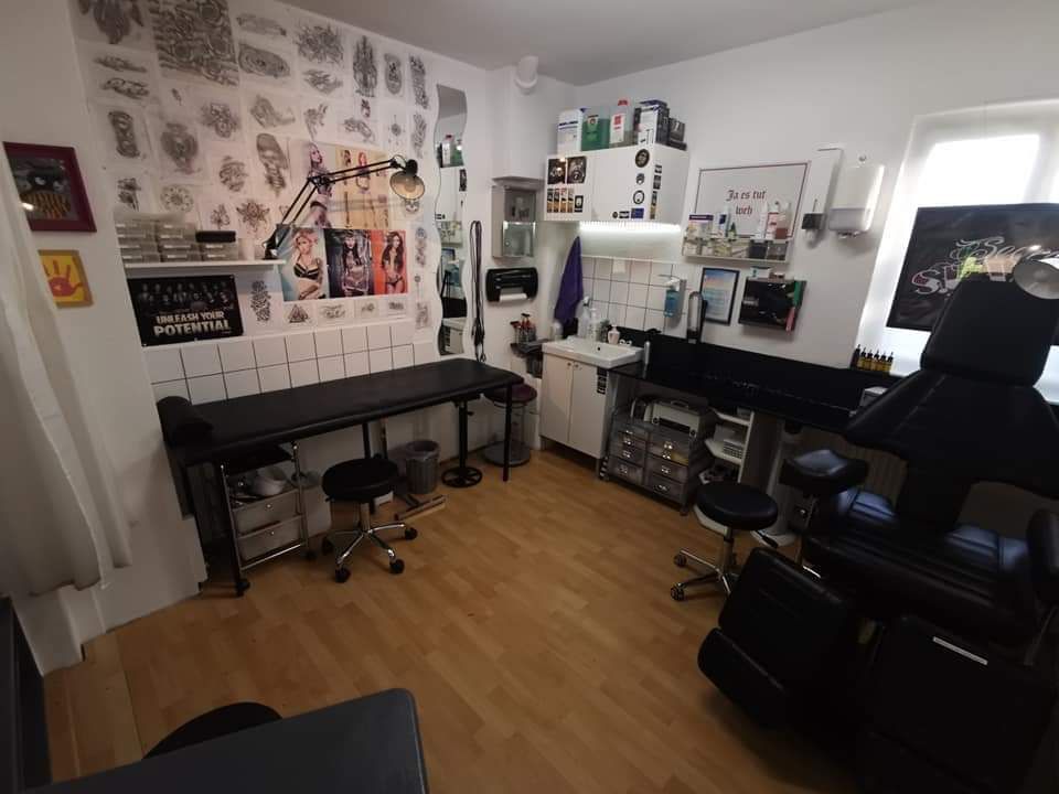 a room with a piano, chair and desk