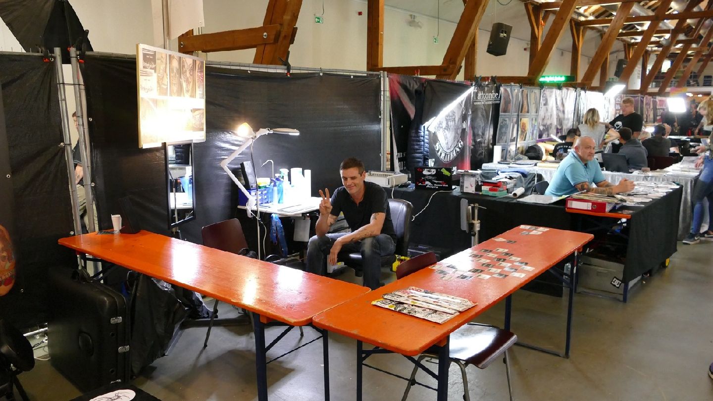 a room with a table and a man sitting at a desk