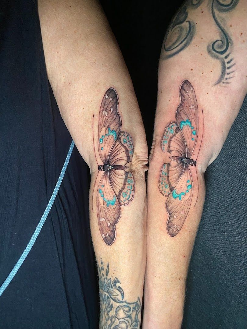 two narben tattoos with butterflies on their arms, freising, germany