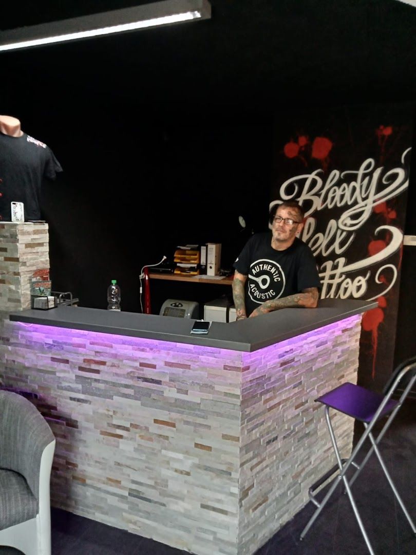 a man is standing behind a counter with a bar