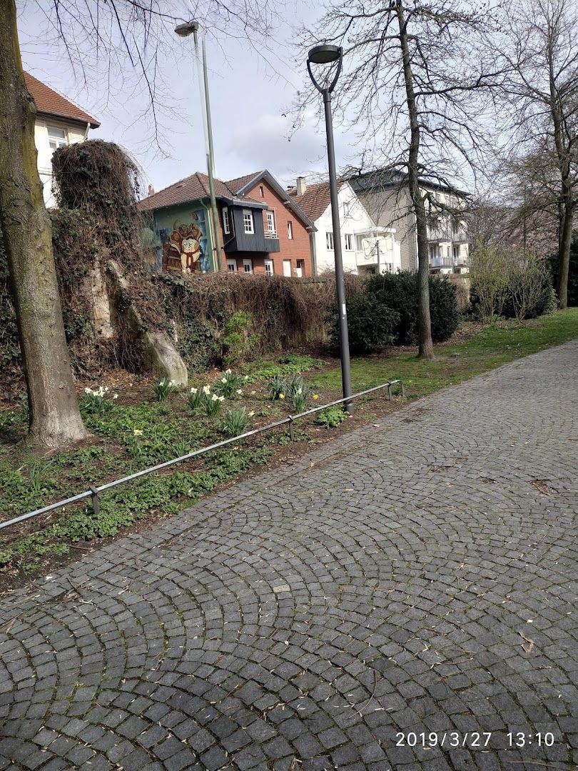 a street with a brick paved road and a tree