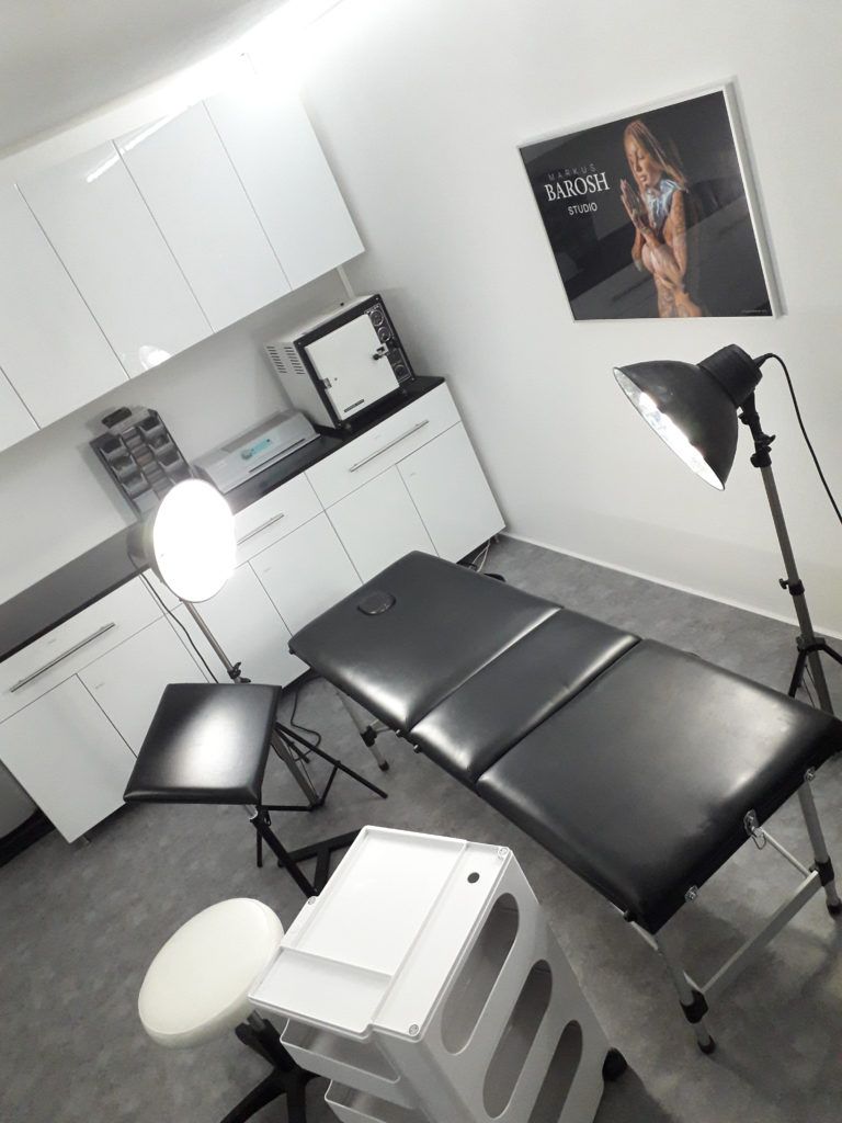 a room with a desk, chair and television