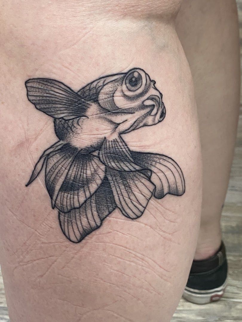 a narben tattoo of a fish on the leg, duisburg, germany