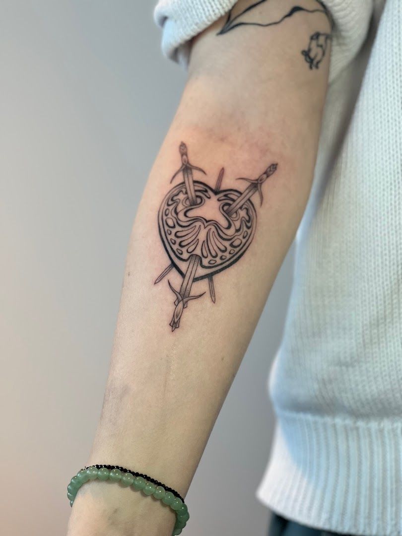 a woman's arm with a cover-up tattoo of a bird on it, böblingen, germany