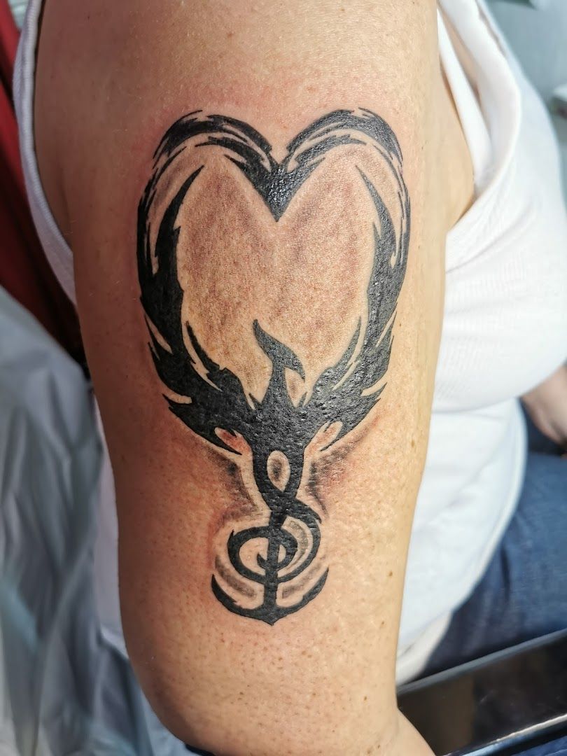 a narben tattoo of a heart with a bird on it, kreisfreie stadt bottrop, germany