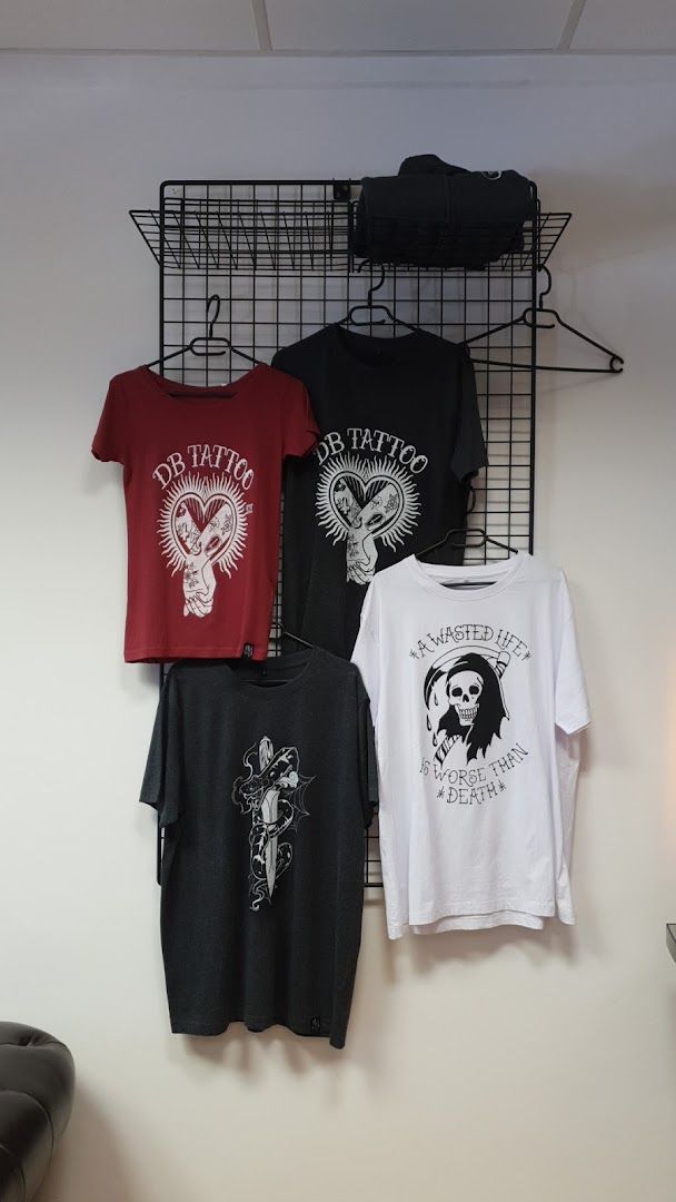 a wall mounted rack with t - shirts and a hat