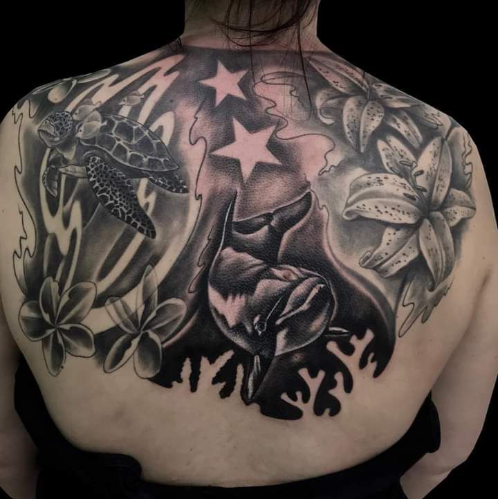 a woman with a cover-up tattoo on her back, teltow-fläming, germany