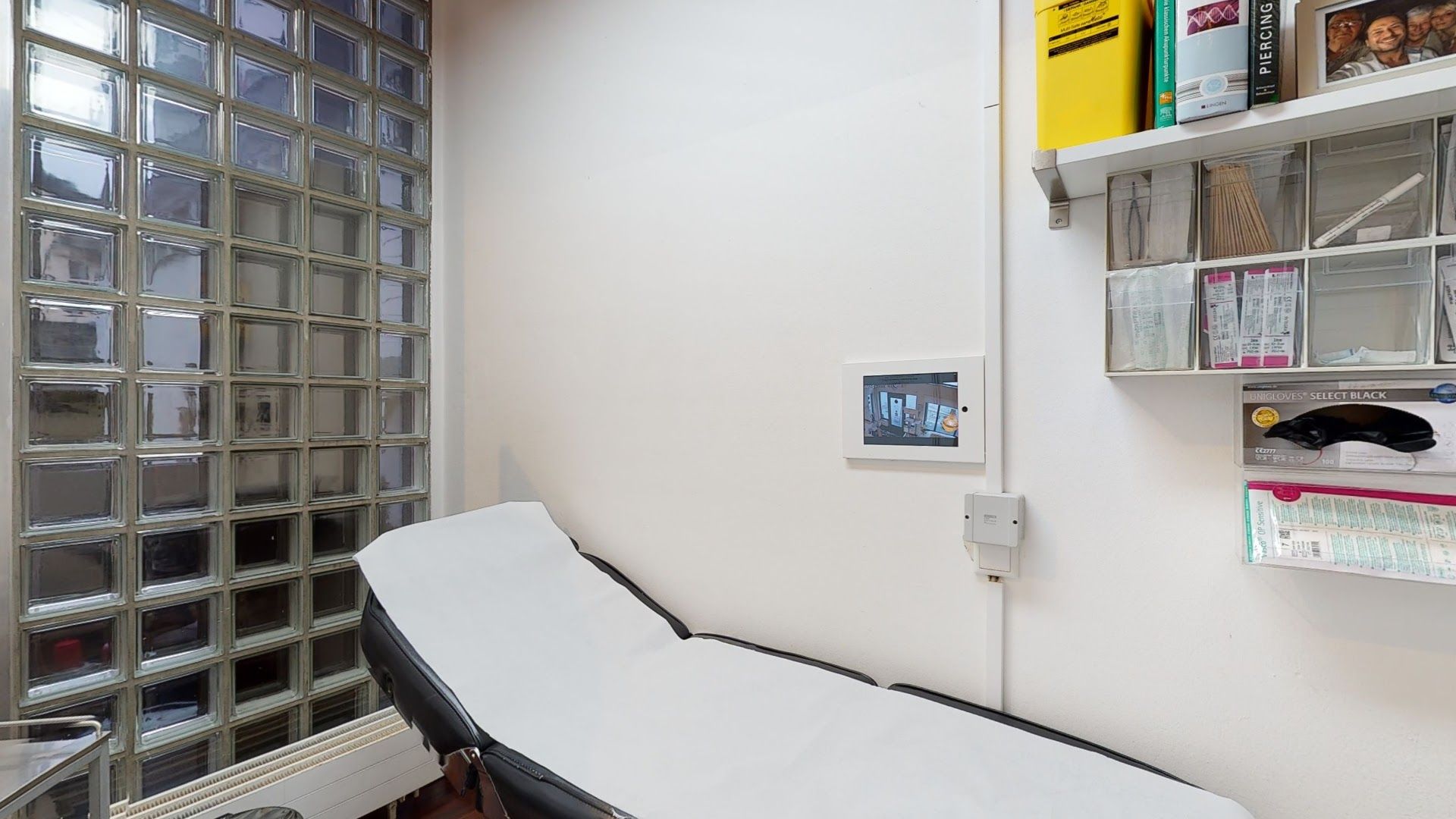 a hospital room with a bed and shelves