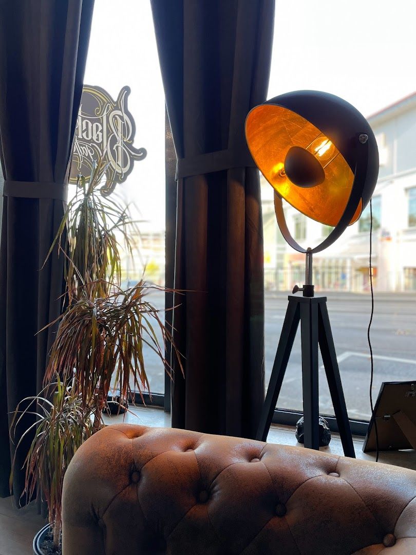 a lamp sitting on top of a table next to a chair